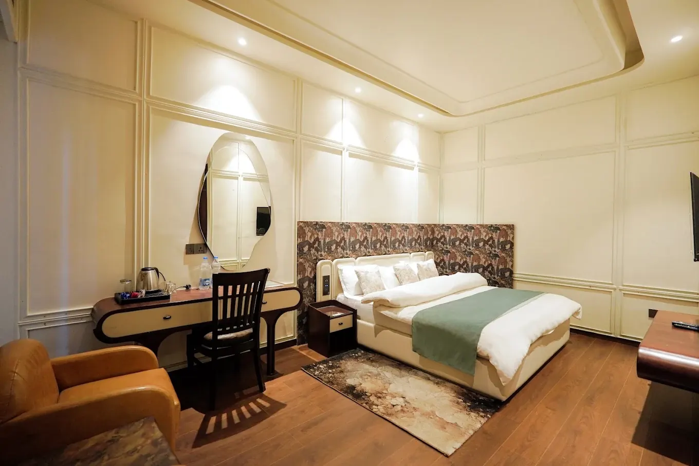 Super Deluxe Room with wooden flooring, writing desk and armchair