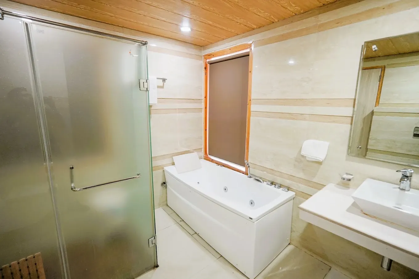 Suite bathroom with bathtub and glass-enclosed shower